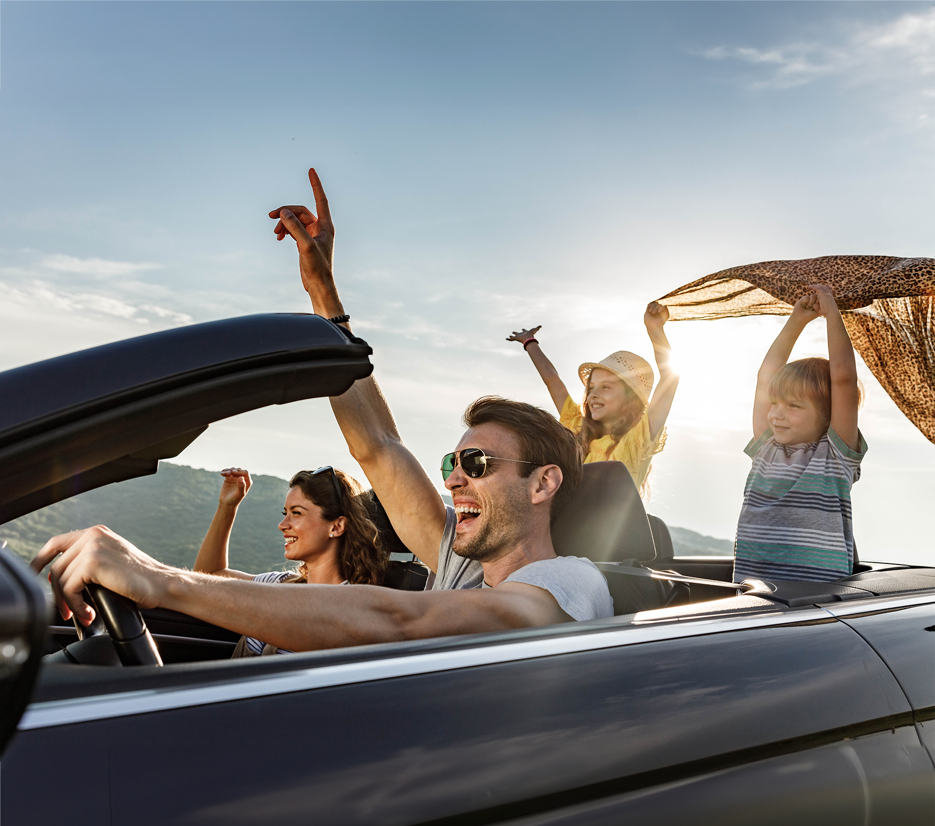 family driving down the road gleefully