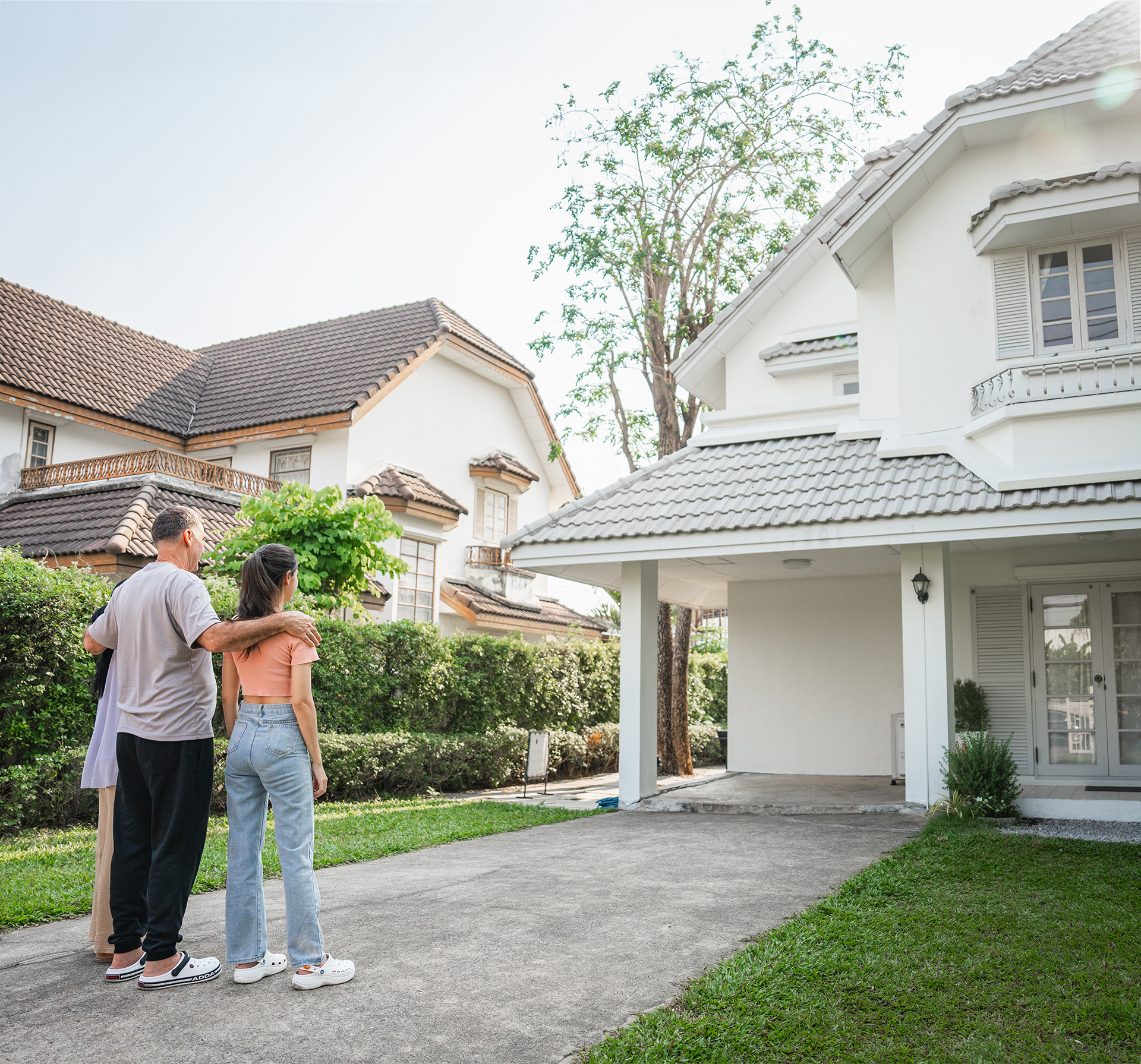 family looking at a house from their yard